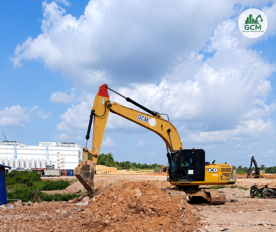 GCM excavator on a soil-clearing job in Iskandar Puteri, with a data centre in the background