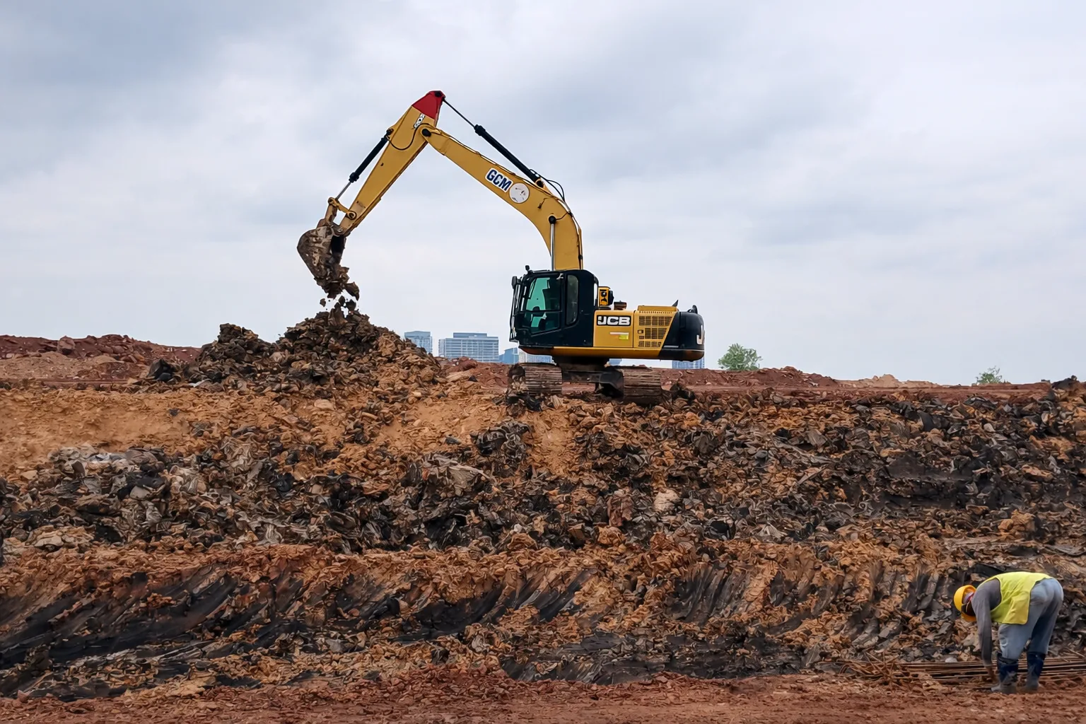 Services Green City Machinery excavator on open earthwork and site clearing ground at Iskandar Puteri, Johor