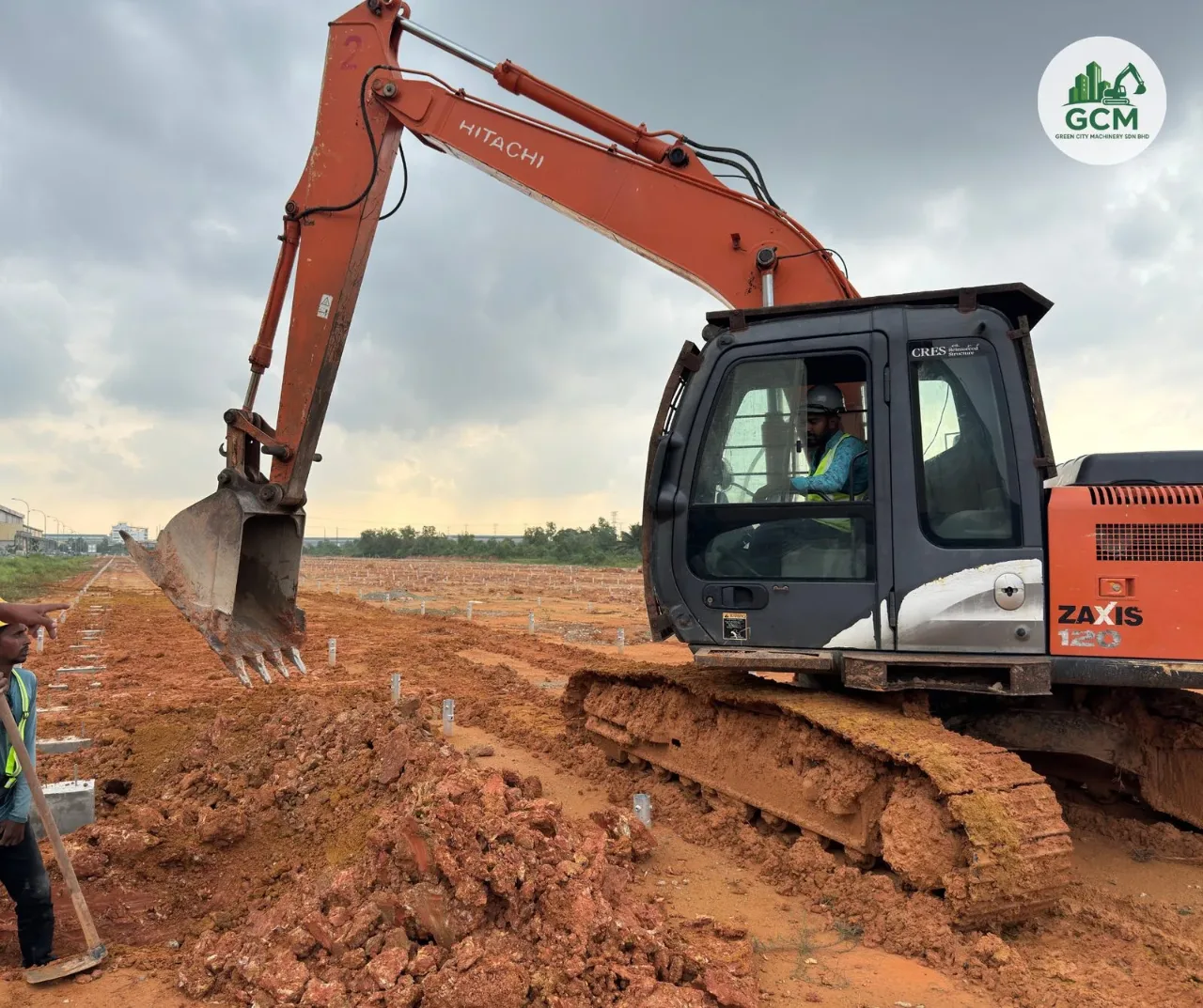 Projects 12-ton excavator levelling ground between installed piles on a solar farm