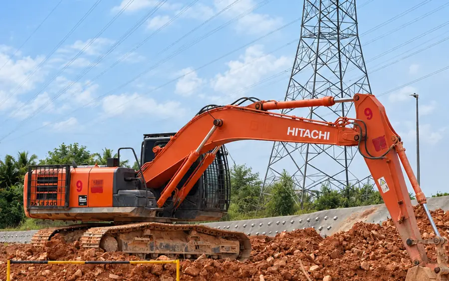 Services Green City Machinery Hitachi excavator on TNB transmission line earthwork beside live overhead lines in Johor